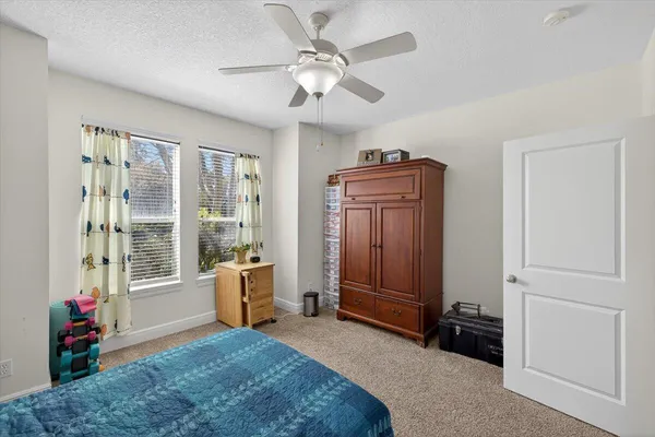 a view of a workspace with a window and lounge chair
