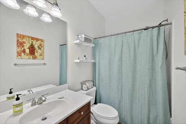 a bathroom with a toilet a sink and a mirror