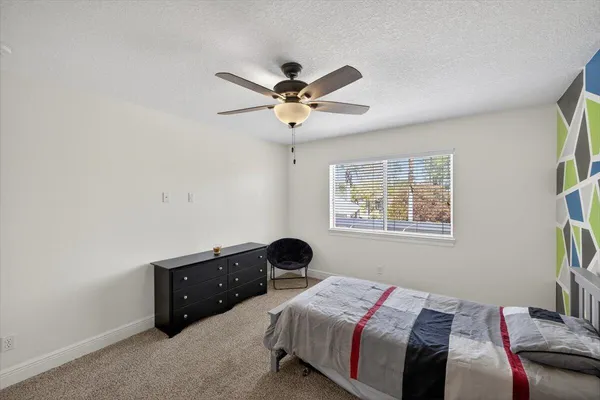 a bedroom with furniture and a book shelf