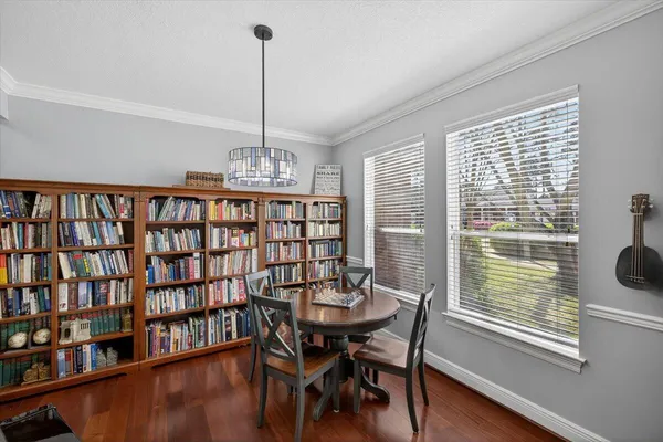 a view of a dining room with furniture window and wooden floor