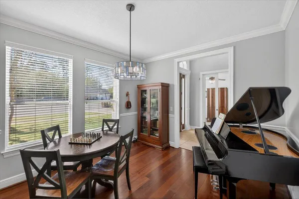 a view of a room that has a table and a chandelier