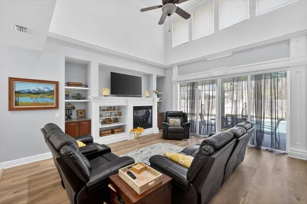 a living room with furniture a fireplace and a flat screen tv