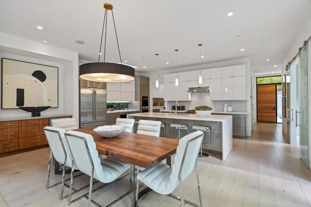 a dining room with furniture and a large window