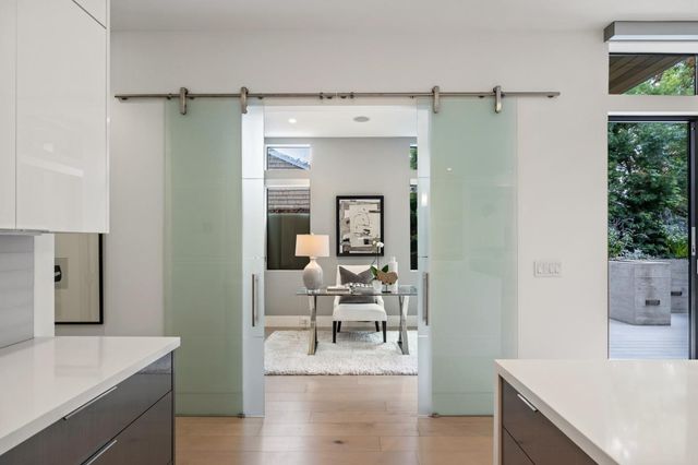 a bedroom with a large bed and a chandelier