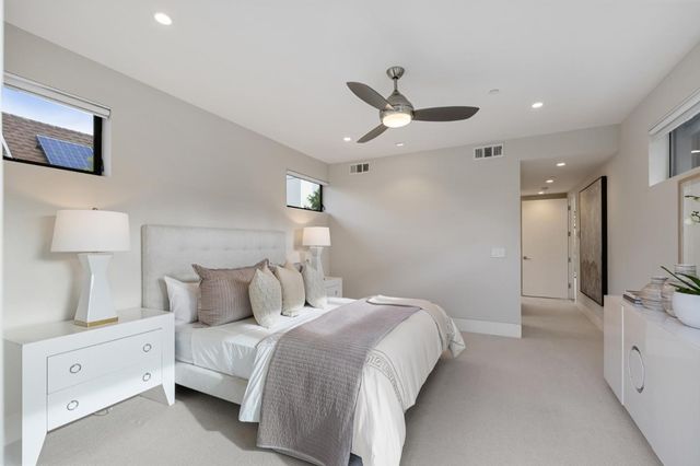 a spacious bathroom with a double vanity sink a large mirror and shower