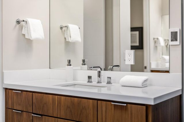 a bedroom with a bed and a painting on the wall