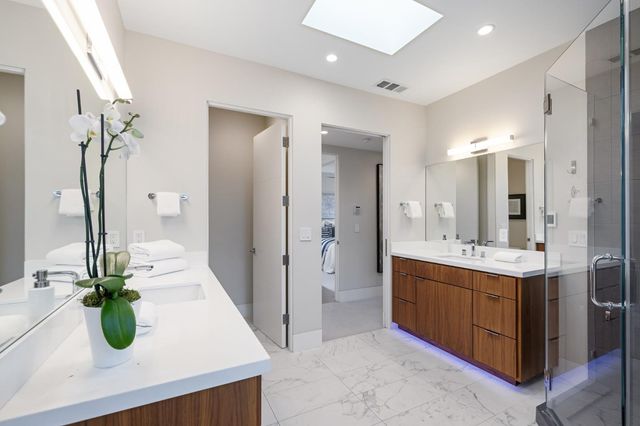 a bedroom with a bed and a painting on the wall