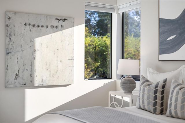 a white vase with flowers on a table