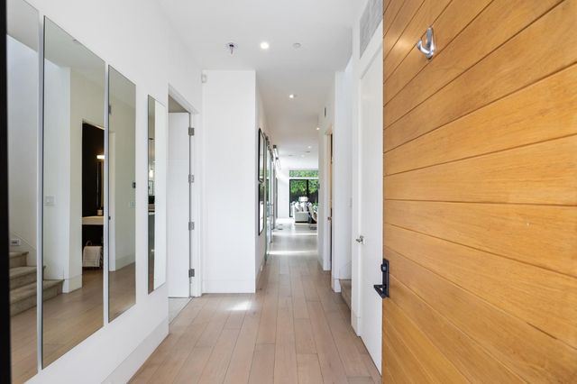 a view of a hallway with wooden floors
