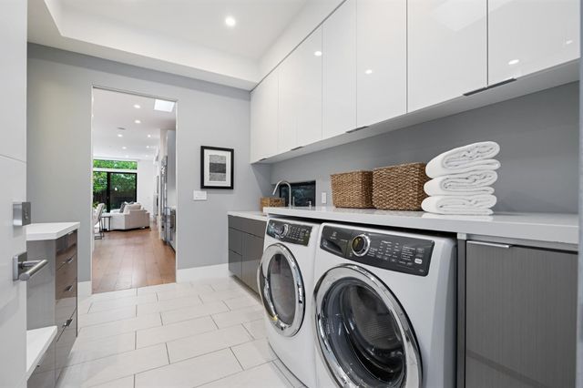 a view of a backyard with plants and large trees