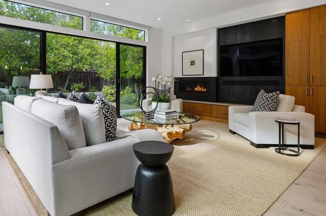 a living room with furniture and a floor to ceiling window