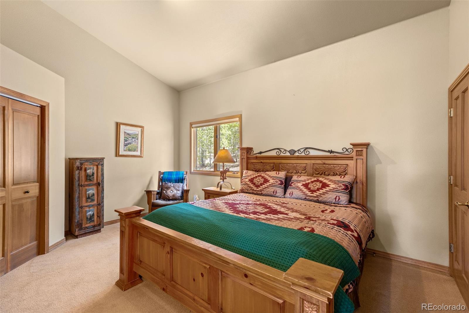 92 Emmett Lode Road, Unit B Breckenridge, CO 80424 - Photo 22 of 50 a bedroom with a bed and a tv
