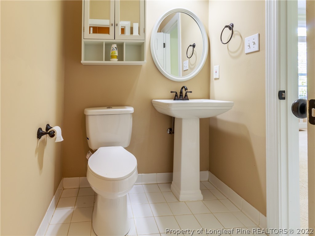 6915 Surrey Road Fayetteville, NC 28306 - Photo 11 of 37 a bathroom with a sink toilet and a mirror