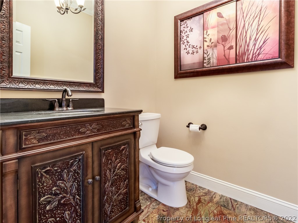 6915 Surrey Road Fayetteville, NC 28306 - Photo 13 of 37 a bathroom with a toilet and a sink