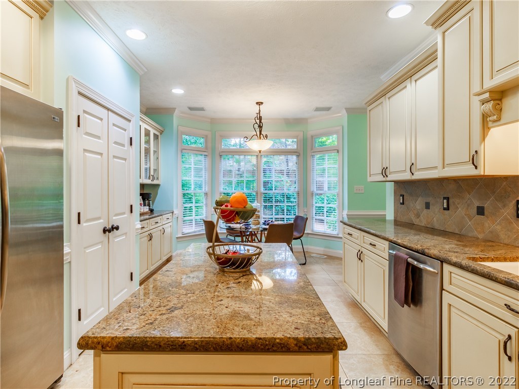 6915 Surrey Road Fayetteville, NC 28306 - Photo 15 of 37 a kitchen with stainless steel appliances granite countertop a stove refrigerator and cabinets