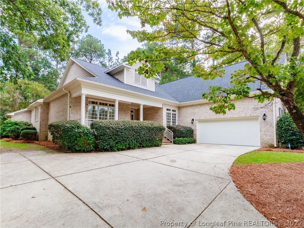 6915 Surrey Road Fayetteville, NC 28306 - Photo 2 of 37 a front view of a house with a garden