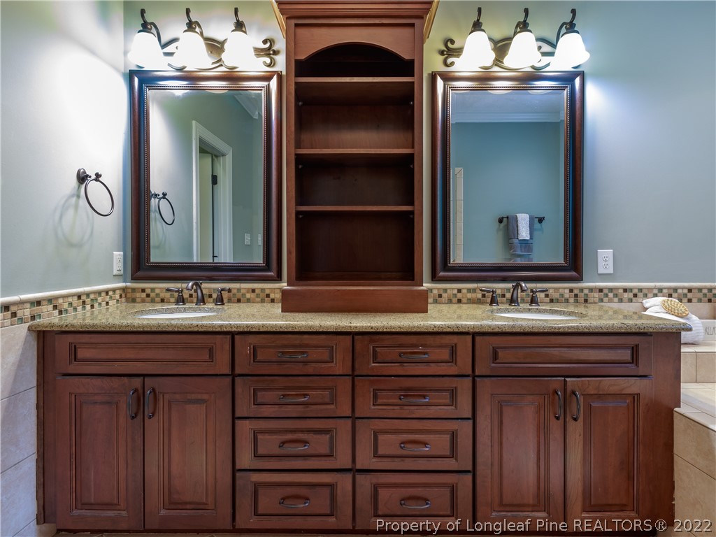 6915 Surrey Road Fayetteville, NC 28306 - Photo 24 of 37 a bathroom with a sink and a mirror