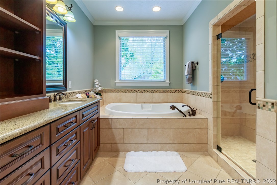 6915 Surrey Road Fayetteville, NC 28306 - Photo 25 of 37 a spacious bathroom with a bathtub and a sink