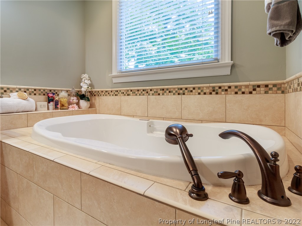 6915 Surrey Road Fayetteville, NC 28306 - Photo 26 of 37 a bathroom with a tub