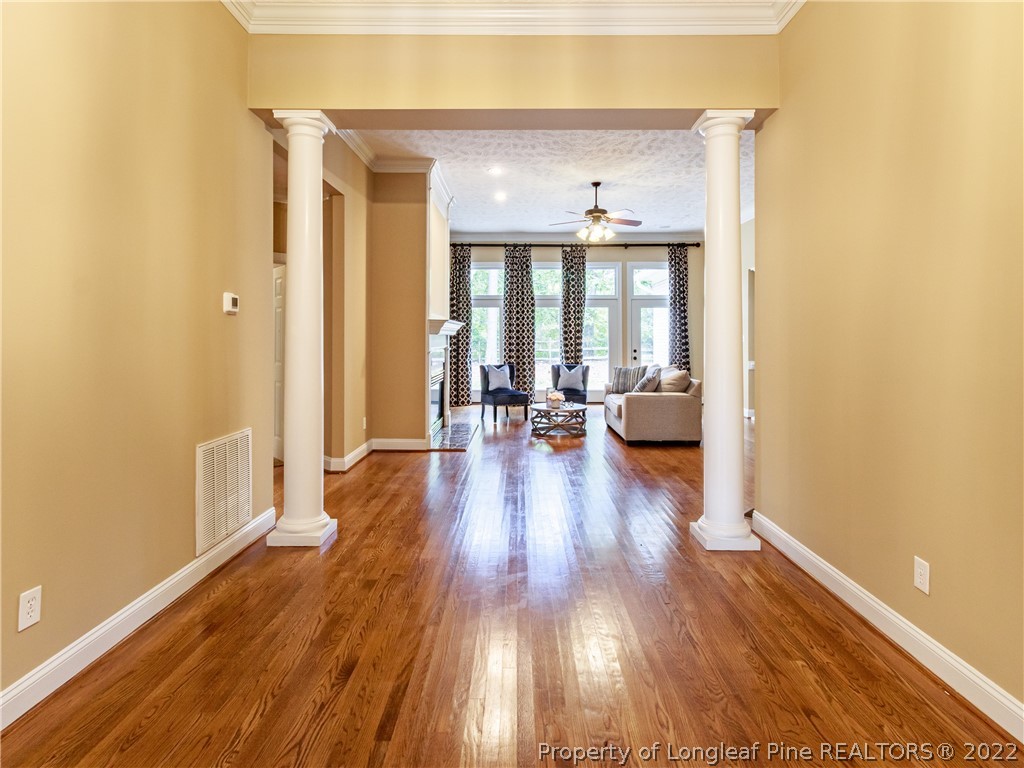 6915 Surrey Road Fayetteville, NC 28306 - Photo 3 of 37 a view of a hallway with wooden floor and furniture