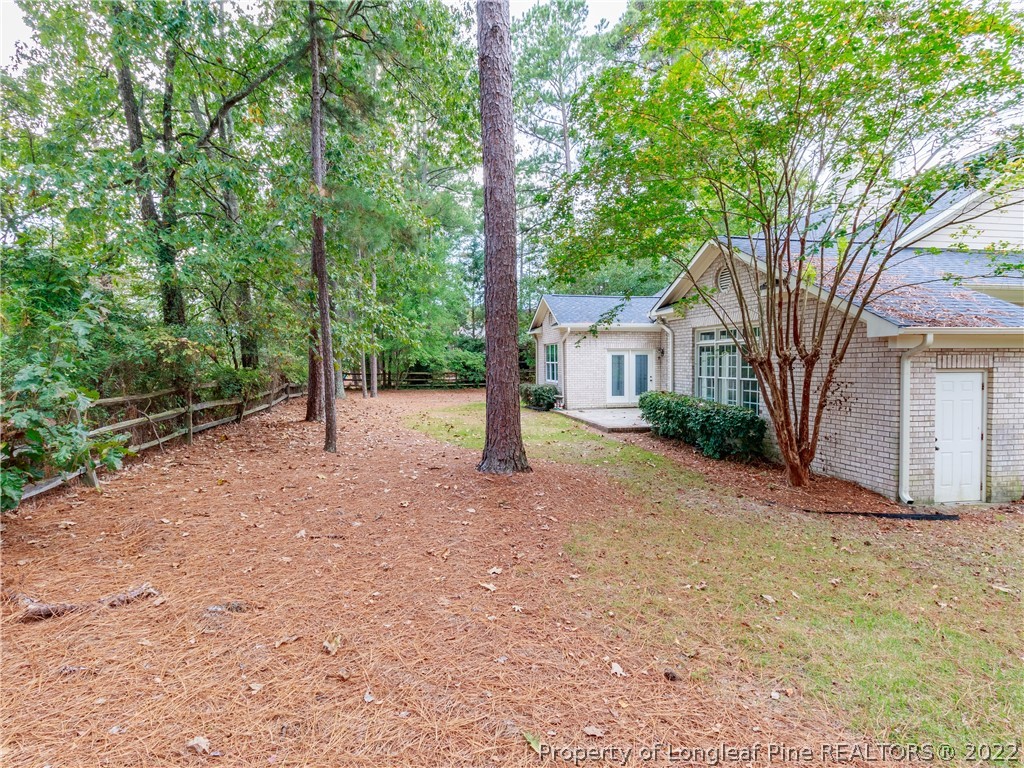 6915 Surrey Road Fayetteville, NC 28306 - Photo 32 of 37 a view of a house with backyard and trees