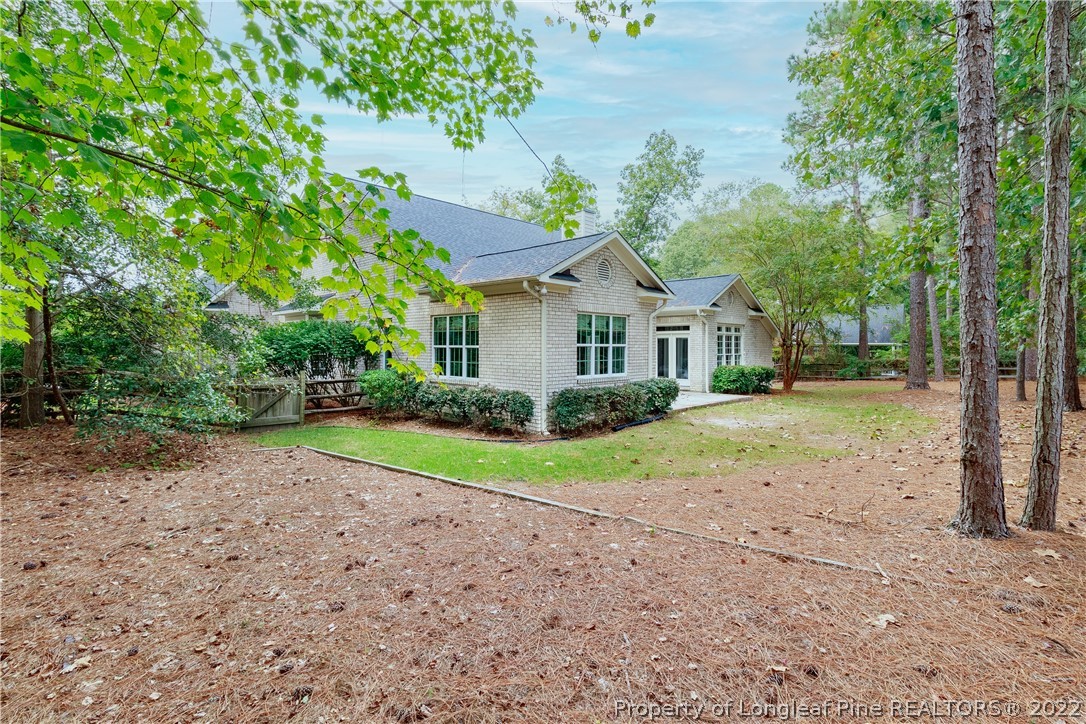 6915 Surrey Road Fayetteville, NC 28306 - Photo 36 of 37 a view of a house with a yard and large trees