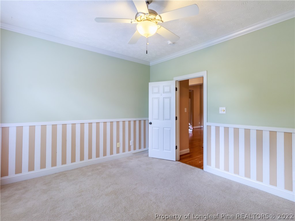 6915 Surrey Road Fayetteville, NC 28306 - Photo 9 of 37 a view of a hallway with a chandelier fan and a livingroom