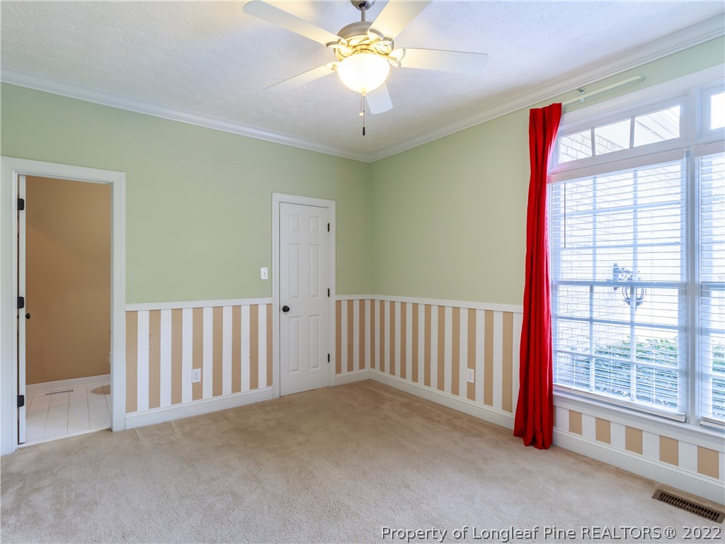 6915 Surrey Road Fayetteville, NC 28306 - Photo 10 of 37 a view of a hallway with a window and chandelier fan