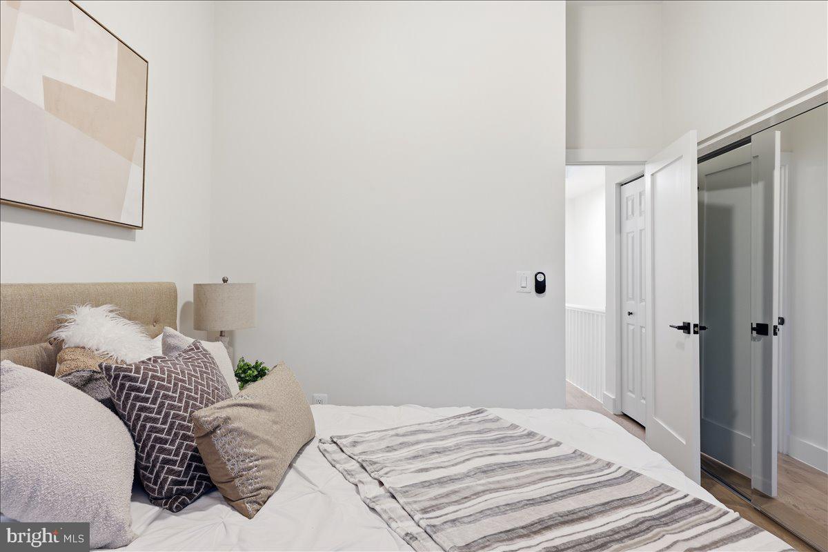 820 13th Street Northeast Washington, DC 20002 - Photo 13 of 38 a bedroom with a bed and a mirror
