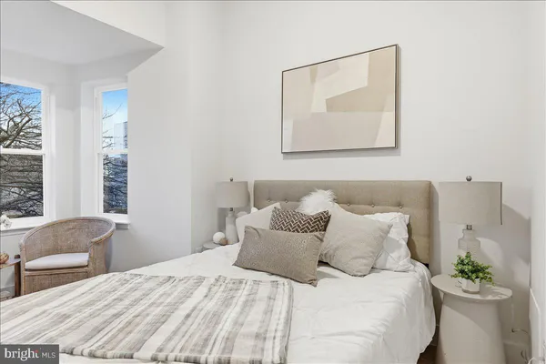 a bedroom with a bed and a chair