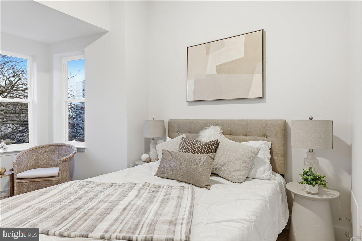 820 13th Street Northeast Washington, DC 20002 - Photo 14 of 38 a bedroom with a bed and a chair