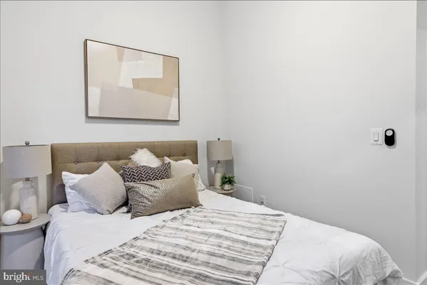 a bedroom with a bed and a lamp
