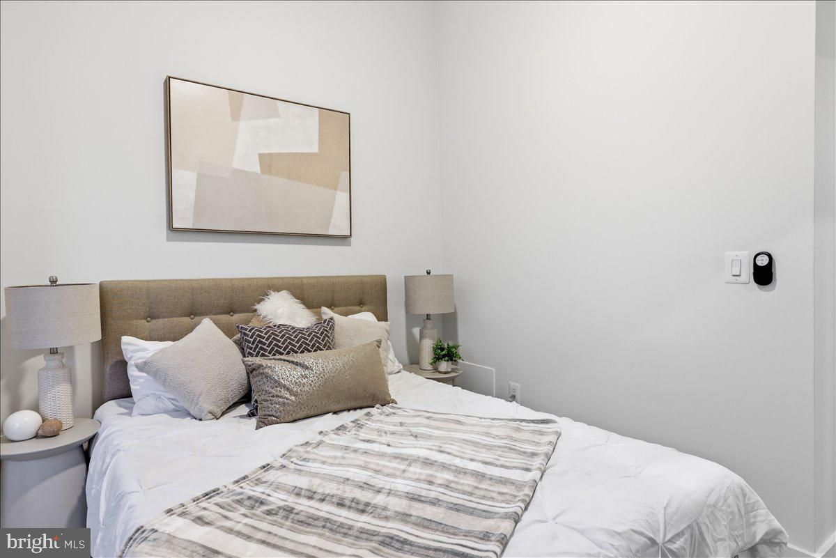820 13th Street Northeast Washington, DC 20002 - Photo 15 of 38 a bedroom with a bed and a lamp
