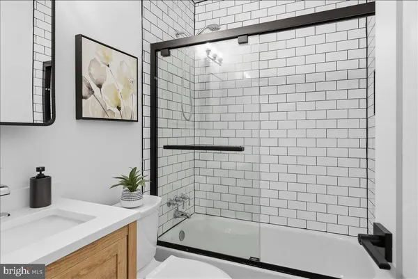 a bathroom with a sink a bathtub and shower