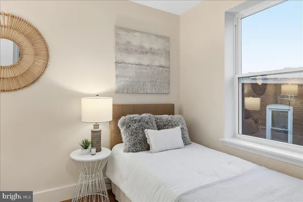 a bedroom with a bed and a table