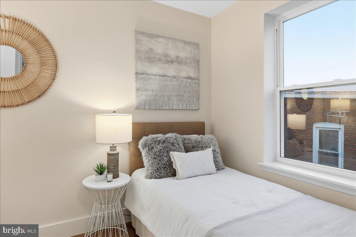 820 13th Street Northeast Washington, DC 20002 - Photo 19 of 38 a bedroom with a bed and a table