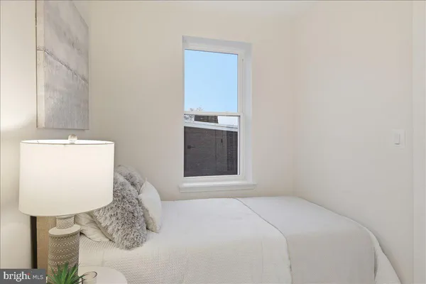 a bedroom with a bed and a wall painting