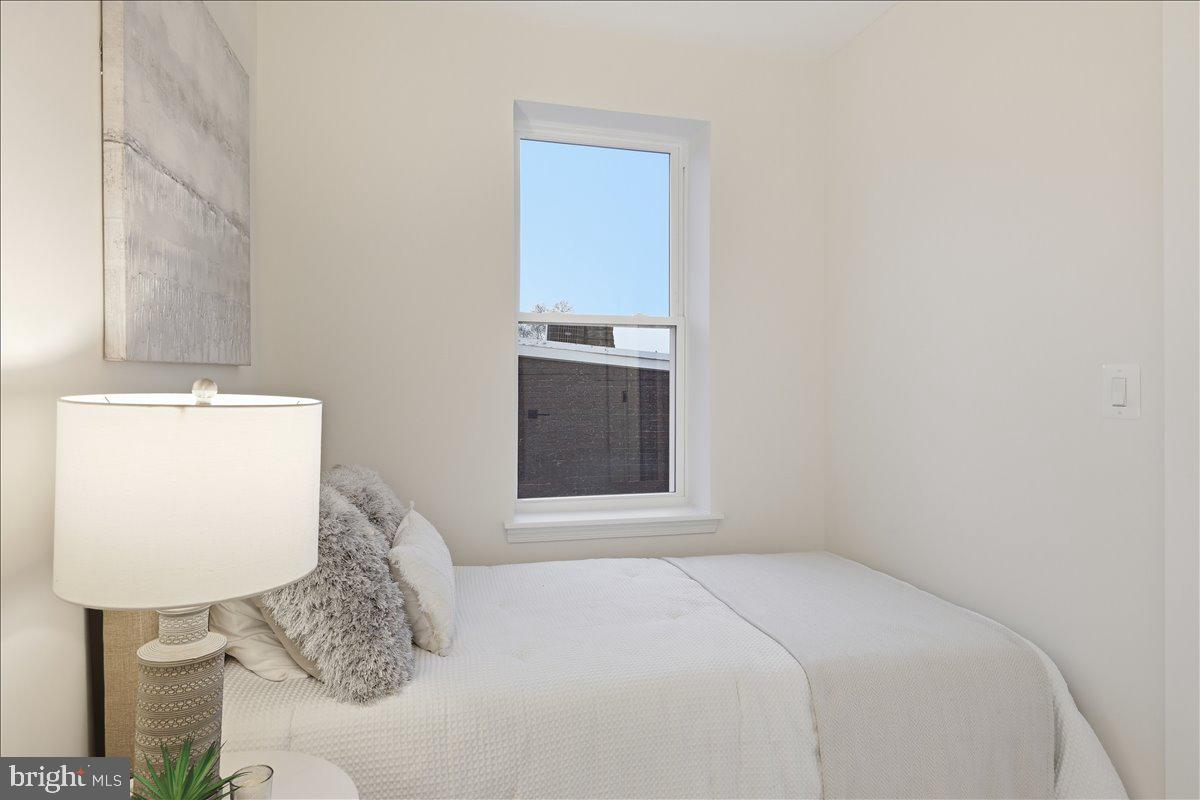820 13th Street Northeast Washington, DC 20002 - Photo 20 of 38 a bedroom with a bed and a wall painting