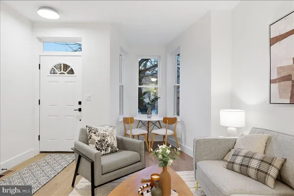a living room with furniture and painting on the wall