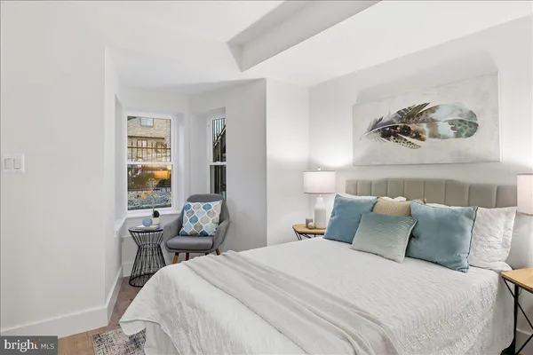 a bedroom with a bed and a table in it