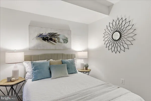 a bedroom with a bed and a couch