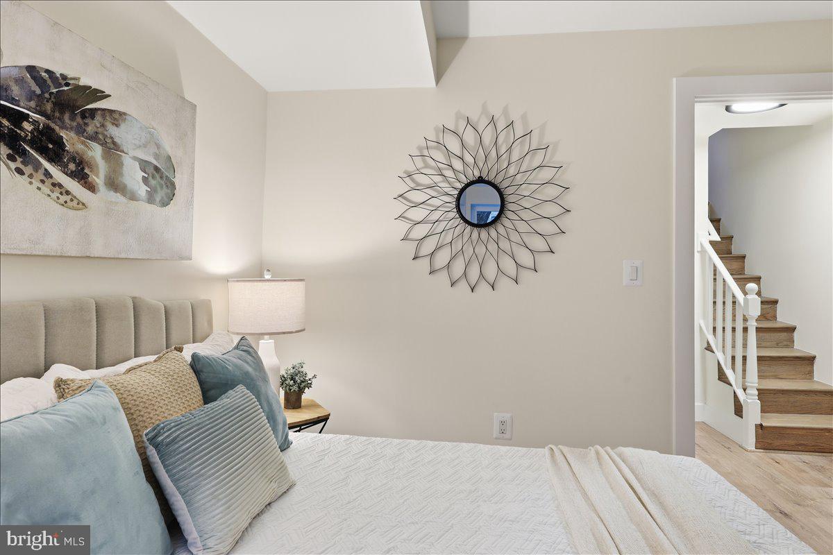 820 13th Street Northeast Washington, DC 20002 - Photo 23 of 38 a bedroom with a bed and a chandelier