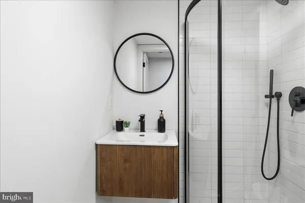 a bathroom with a sink vanity and a mirror
