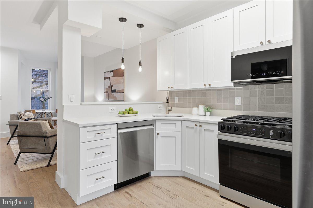 820 13th Street Northeast Washington, DC 20002 - Photo 8 of 38 a kitchen with cabinets stainless steel appliances and wooden floor