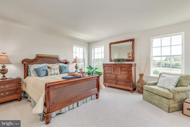 a bedroom with a bed and with furniture
