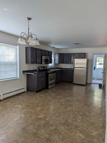 a kitchen with stainless steel appliances granite countertop a stove and a sink with granite countertops