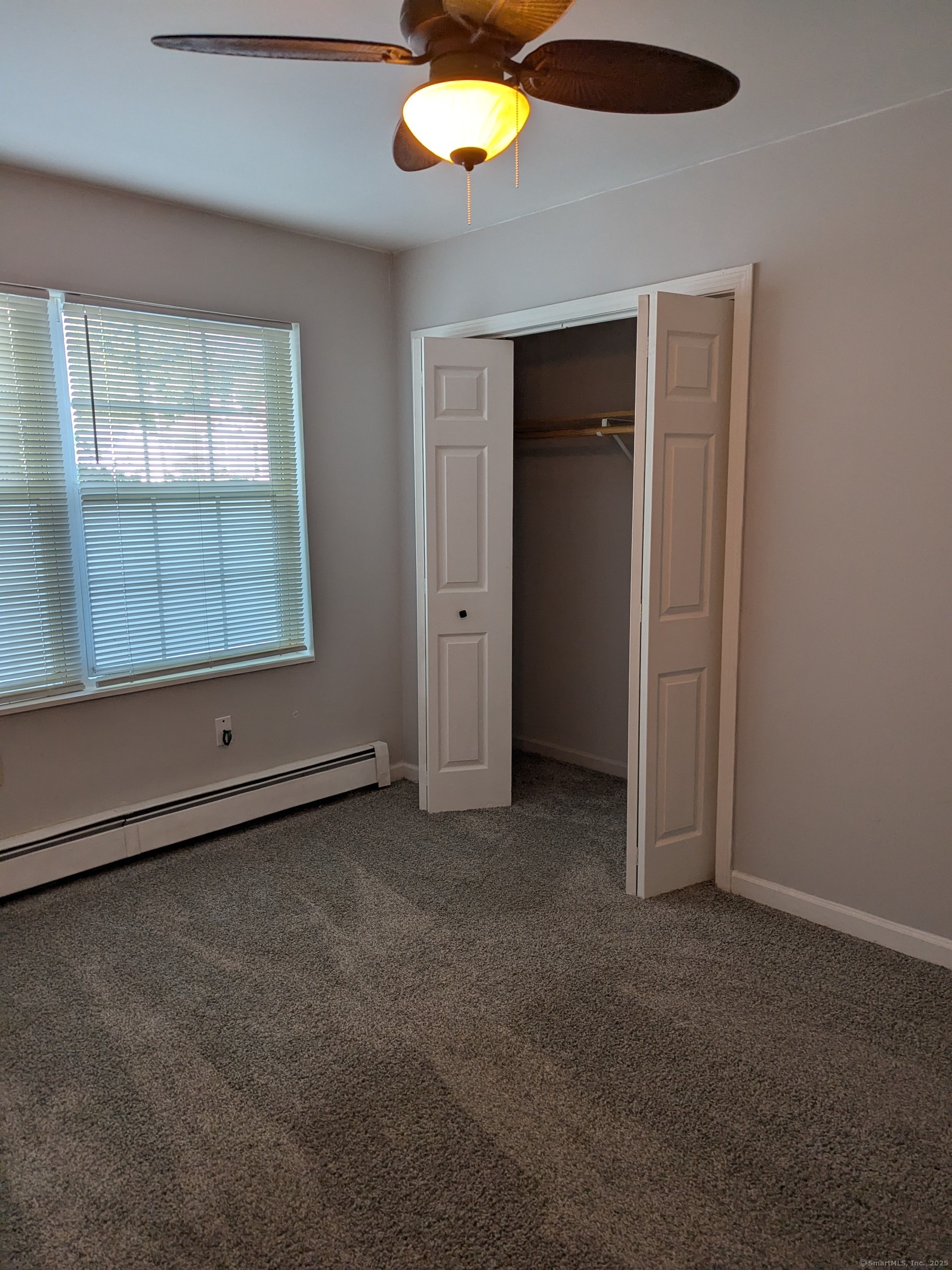 151 Enfield Street Hartford, CT 06112 - Photo 22 of 35 an empty room with a window and a ceiling fan