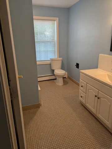 a spacious bathroom with a toilet sink and a mirror
