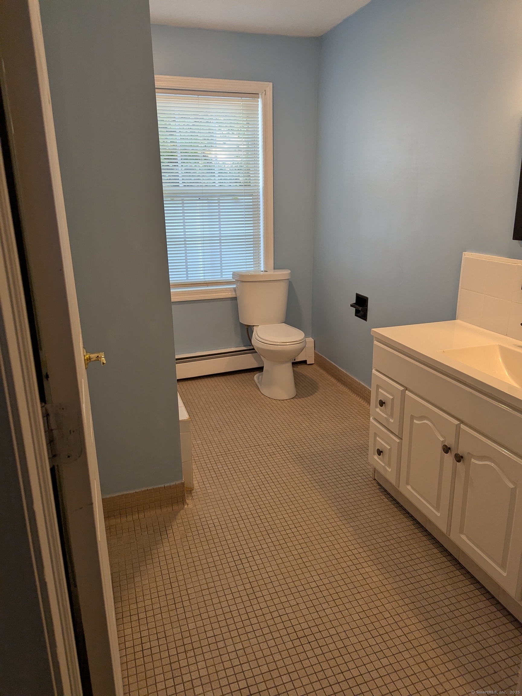 151 Enfield Street Hartford, CT 06112 - Photo 25 of 35 a spacious bathroom with a toilet sink and a mirror
