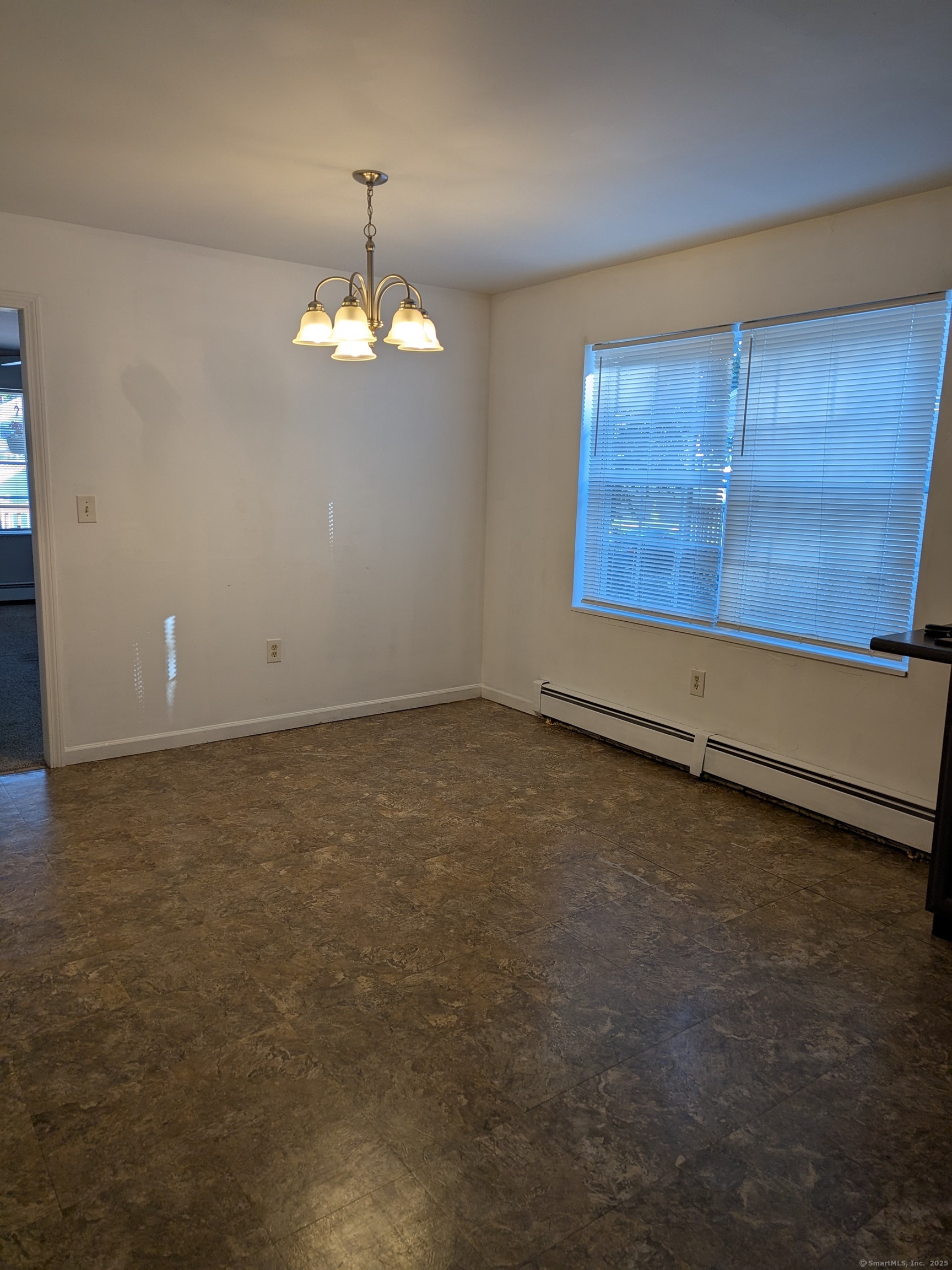 151 Enfield Street Hartford, CT 06112 - Photo 31 of 35 an empty room with chandelier fan and windows